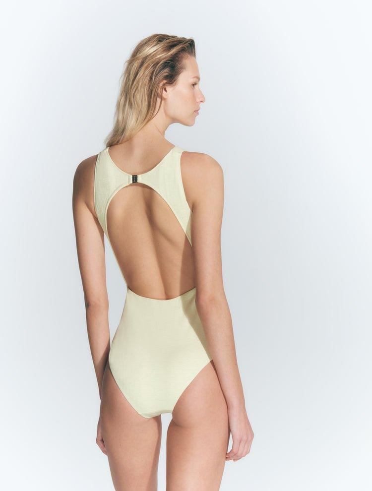 "Model wearing the Jackie Yellow Swimsuit from the back, highlighting the open back design and gold-plated clasp closure."