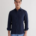Front View: Model in James Dark Blue Shirt - MOEVA Luxury Swimwear, Spread Collar, Buttoned Cuffs, Button Fastening, Long-Sleeved, Slim Fit, MOEVA Luxury Swimwear