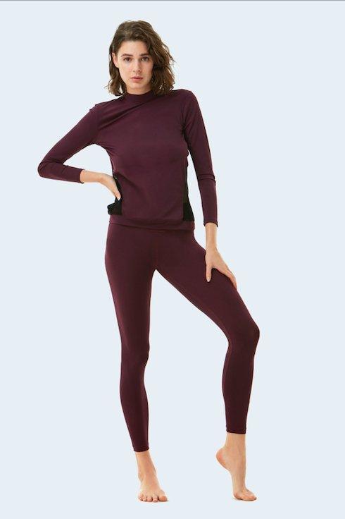 "Jasmine Prune Top front view featuring long sleeves and intricate mesh detailing. The stylish design showcases a sleek, modern look with rich prune color."