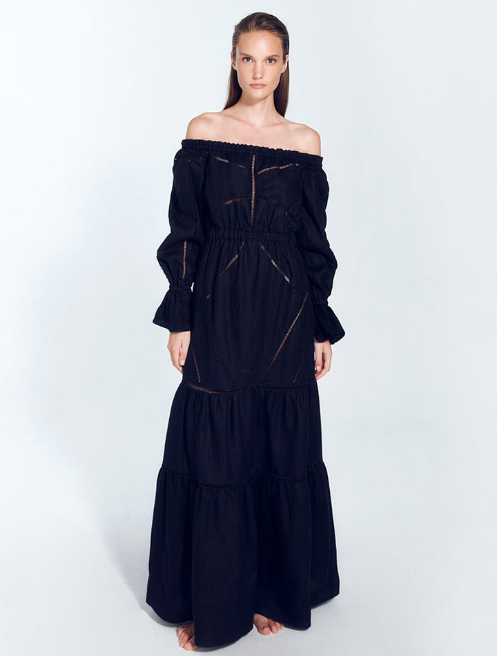 Front View: Model in Jealine Black Dress - MOEVA Luxury Swimwear, Maxi Dress, Ruffled Skirt, Puffed Sleeves, MOEVA Luxury Swimwear