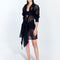 "Model wearing Jesabel Black Mini Shirt Dress with tie-front panel, standing on a beach."