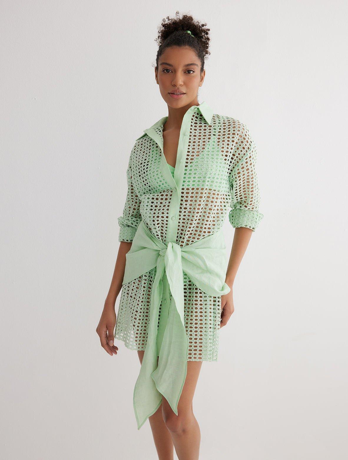 "Front view of the Jesabel Mint Green Dress, showcasing its mini shirt dress design with square patterned Broderie Anglaise cotton, button front, pointed collar, and waist-cinching tie."