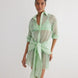 "Front view of the Jesabel Mint Green Dress, showcasing its mini shirt dress design with square patterned Broderie Anglaise cotton, button front, pointed collar, and waist-cinching tie."