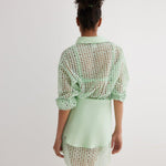 "Back view of the Jesabel Mint Green Dress, highlighting its mini length, button-down closure, and waist panel with a tie at the front."