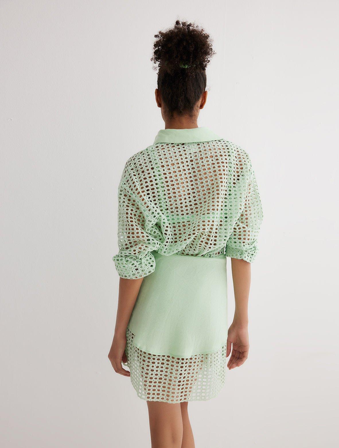 "Back view of the Jesabel Mint Green Dress, highlighting its mini length, button-down closure, and waist panel with a tie at the front."