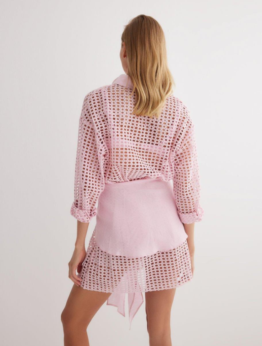 "Back view of the Jesabel Pink Dress, highlighting its mini length, button-down detail, and waist panel with a tie at the front."