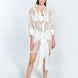 Front View: Model in Jesabel White Dress - MOEVA Luxury Swimwear, Broderie Anglaise Fabric, Button Fastening Through Front, Layered with Panel, Day to Night Mini Dress, MOEVA Luxury Swimwear
