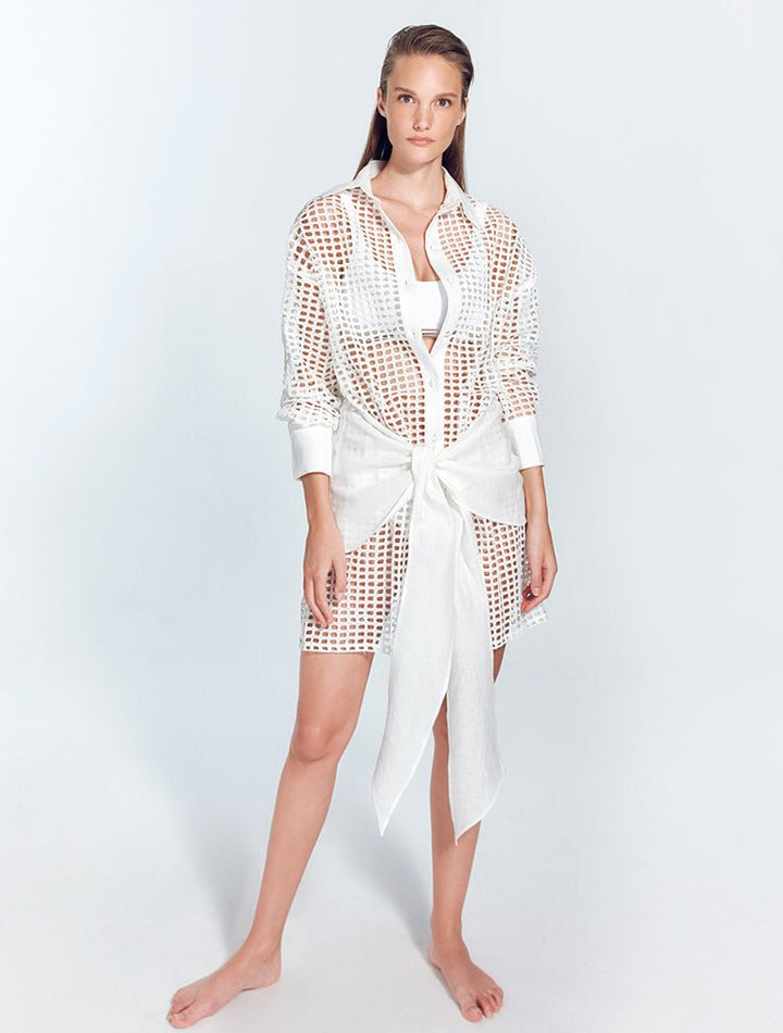 Front View: Model in Jesabel White Dress - MOEVA Luxury Swimwear, Broderie Anglaise Fabric, Button Fastening Through Front, Layered with Panel, Day to Night Mini Dress, MOEVA Luxury Swimwear