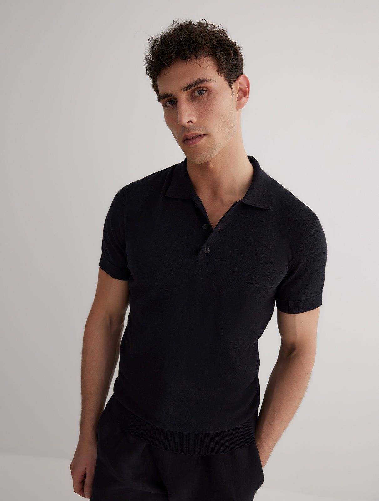 Front View: Model in Johan Black Polo Shirt - MOEVA Luxury Swimwear, Open Collar, Polo Shirt, Short-Sleeved, Cashmere & Cotton-Blend, Slim Fit, MOEVA Luxury Swimwear