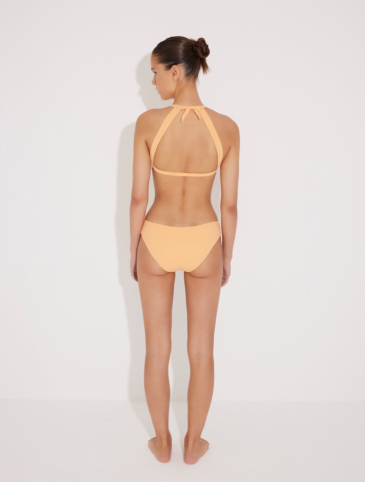 Front View: Jolanda Orange Monokini on Model - Tie Neck Swimsuit, Moderate Bottom Coverage, Italian Fabric, Crushed Round Gold Accessory, MOEVA Luxury Swimwear
