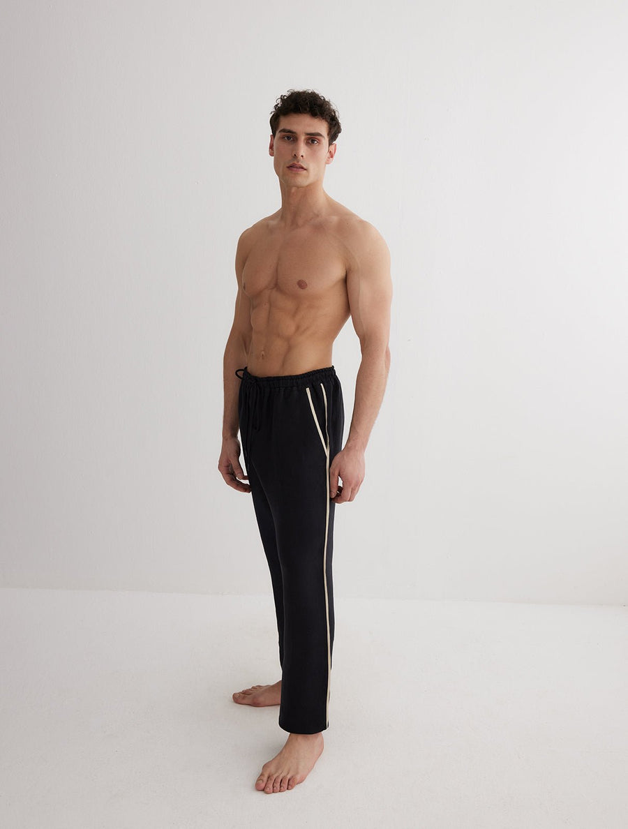 Front View: Model in Joseph Black Pants - MOEVA Luxury Swimwear, Relaxed Fit, Muslin Fabric, MOEVA Luxury Swimwear