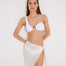 "Front view of a model wearing a white sarong with a gold twisted accessory tied at the side. The sarong features a flowing, textured fabric."