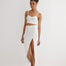 "Front view of a model in the Jules skirt, highlighting the elastic waistband and asymmetrical cut in white."