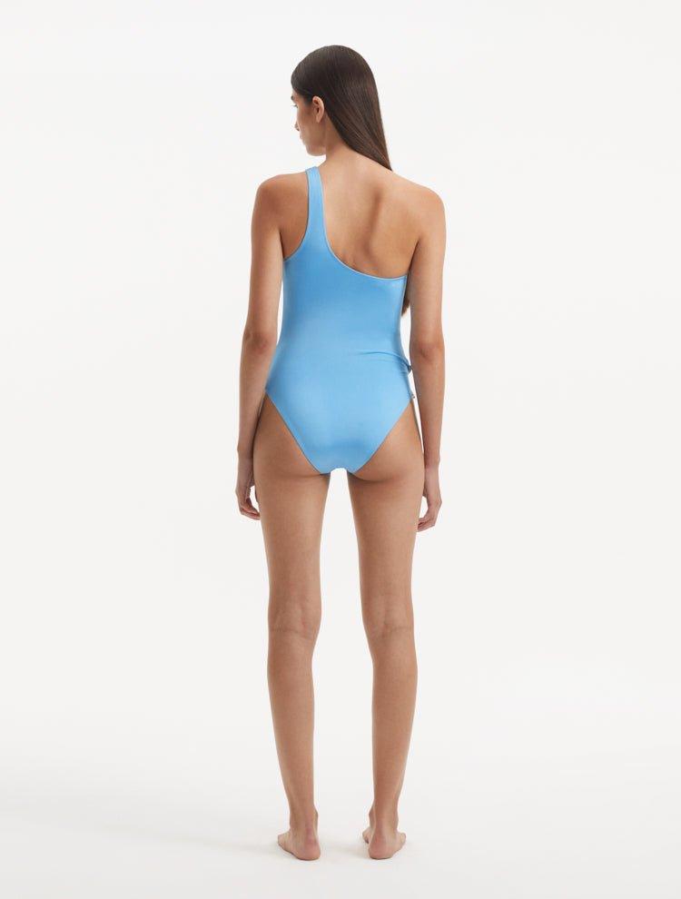 "Back view of the Kaimana Baby Blue Swimsuit, emphasizing the elegant cut and full coverage."