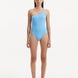 Model wearing the Kaimana Baby Blue Swimsuit from the front, showcasing the one-shoulder design and full bottom coverage.