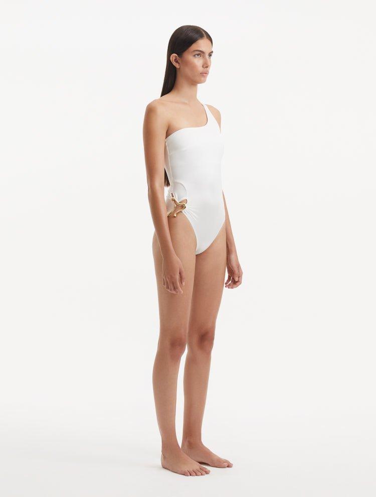 Side view of the Kaimana White Swimsuit, focusing on the one-shoulder silhouette and luxurious design.