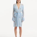 "Model wearing Kenga Baby Blue Kaftan from the front, showcasing the knee-length cut, intricate hand-knitted meshwork, and fringe details."