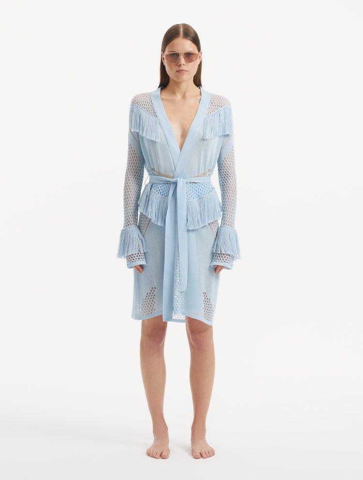 "Model wearing Kenga Baby Blue Kaftan from the front, showcasing the knee-length cut, intricate hand-knitted meshwork, and fringe details."