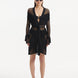"Model wearing Kenga Black Kaftan from the front, highlighting the knee-length cut, intricate hand-knitted texture, and fringe details."