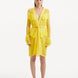 "Model showcasing the Kenga Yellow Kaftan from the front, highlighting the knee-length cut, intricate hand-knitted pattern, and playful fringe detailing."