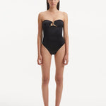 Discover the enchanting intersection of fashion, art, and athleticism with the Kenna Black Swimsuit. Crafted as part of our groundbreaking collection, this exquisite piece invites you to immerse yourself in a narrative that fuses the dynamism of sports and the fluid grace of water, offering a fresh take on elegance and empowerment.   Minimalist Silhouette The Kenna black swimsuit exudes sophistication and modernity with its striking strapless design. This silhouette pays tribute to the fluid nature of water