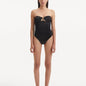 Discover the enchanting intersection of fashion, art, and athleticism with the Kenna Black Swimsuit. Crafted as part of our groundbreaking collection, this exquisite piece invites you to immerse yourself in a narrative that fuses the dynamism of sports and the fluid grace of water, offering a fresh take on elegance and empowerment.   Minimalist Silhouette The Kenna black swimsuit exudes sophistication and modernity with its striking strapless design. This silhouette pays tribute to the fluid nature of water