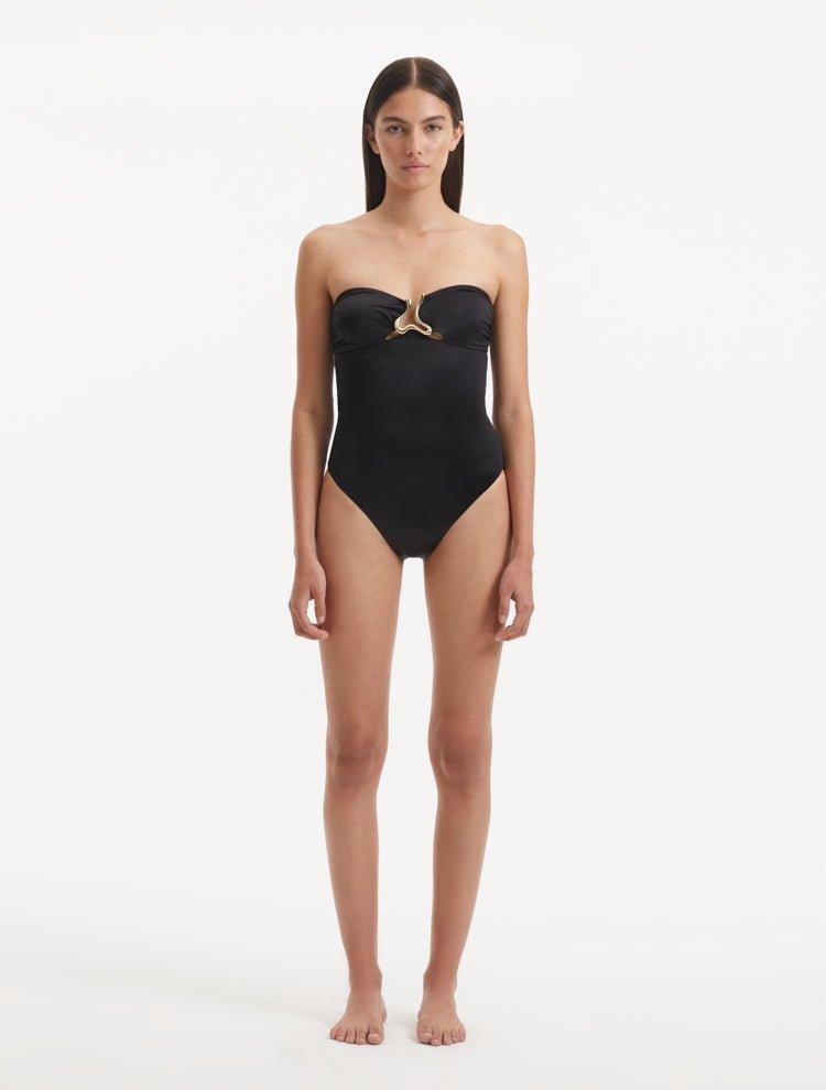 Discover the enchanting intersection of fashion, art, and athleticism with the Kenna Black Swimsuit. Crafted as part of our groundbreaking collection, this exquisite piece invites you to immerse yourself in a narrative that fuses the dynamism of sports and the fluid grace of water, offering a fresh take on elegance and empowerment.   Minimalist Silhouette The Kenna black swimsuit exudes sophistication and modernity with its striking strapless design. This silhouette pays tribute to the fluid nature of water