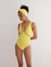 Front View: Model in Klara Yellow Swimsuit - MOEVA Luxury Swimwear, Removable Paddings, Deep V Neckline, Chain Details Underbust, Chain Details on the V Neckline, Moderate Bottom Coverage, One Piece Soft Touch Fabric, MOEVA Luxury Swimwear