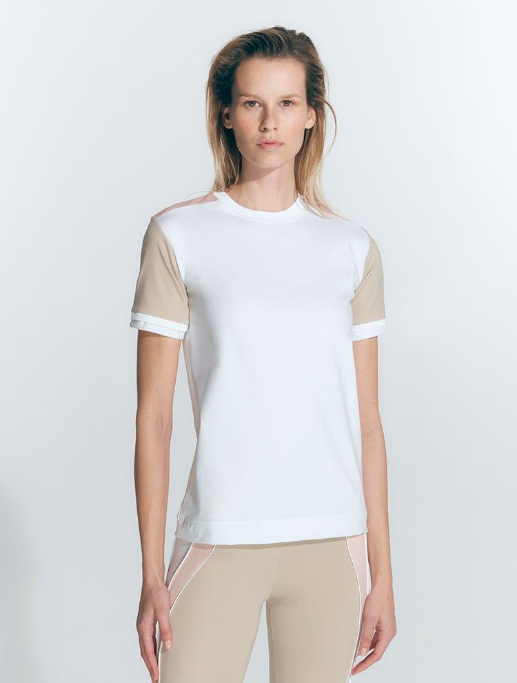 "Front view of a model wearing the Leticia White Top, showcasing its modern style."