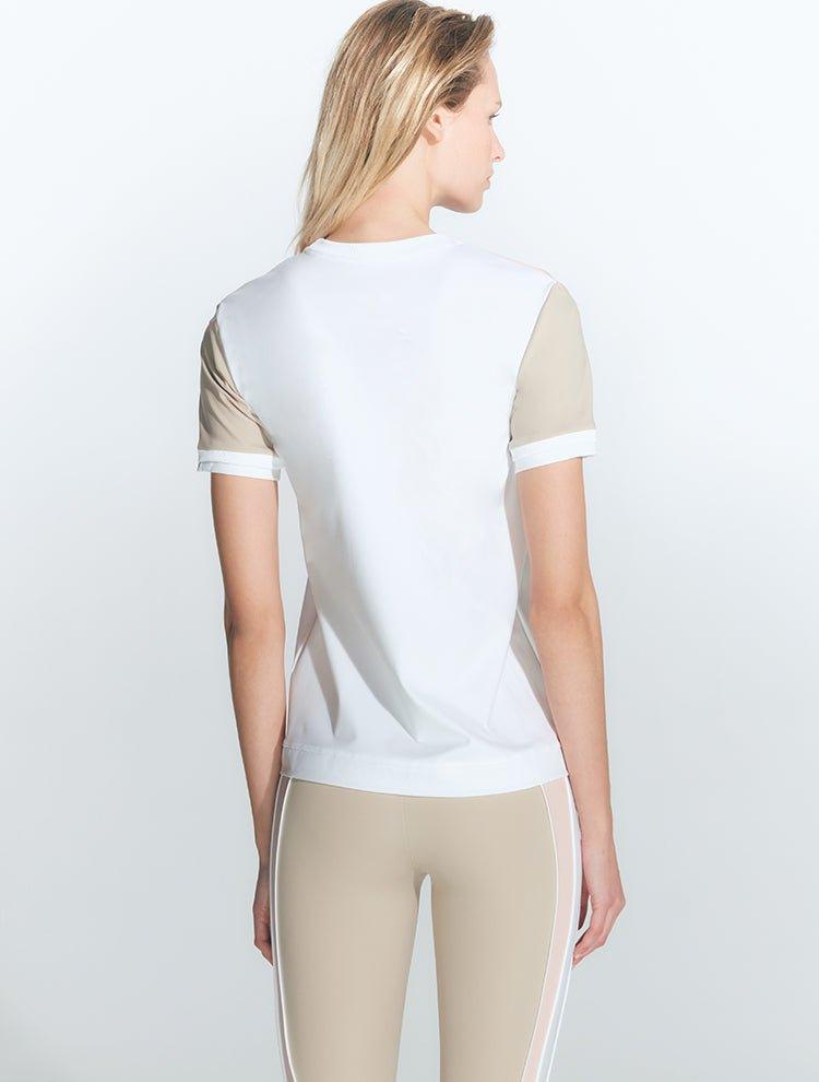 "Back view of the Leticia White Top on a model, emphasizing its flattering silhouette."