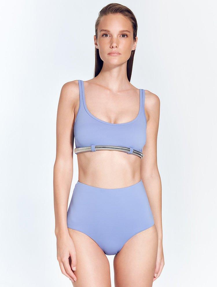 "Model wearing the Liliana Blue Bikini Top from the front, showcasing the scoop neckline, thick straps, and omega chain detail for a sporty-chic look."