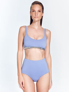 Front View: Model in Liliana Blue Bikini Top - MOEVA Luxury Swimwear, Scoop Neck, Omega Chain Accessory, MOEVA Luxury Swimwear