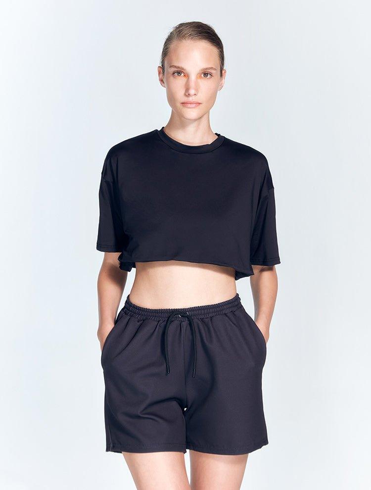 "Front view of Linette Black Shorts showing mesh detailing and a bold geometric design. The shorts are made of stretchable fabric for a comfortable and flexible fit."