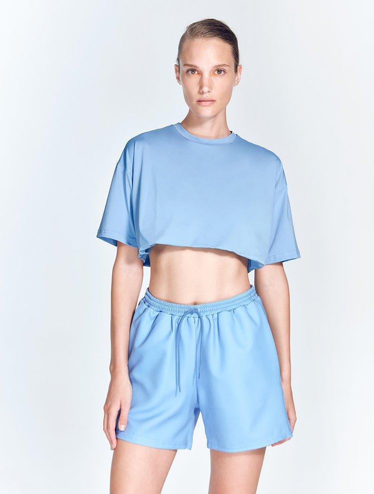 " Front view of Linette Blue Shorts featuring intricate mesh detailing and a bold geometric design. The shorts are made from stretchable fabric for a comfortable, flexible fit. "