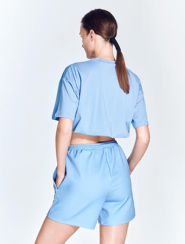 "Back view of Linette Blue Shorts showcasing the mesh detailing and geometric design. The shorts are made from stretchable fabric, ensuring a flexible and comfortable fit."