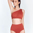 "Front view of the Livia Red Ochre Bikini Bottom highlighting its high-waisted design, smooth fabric, and moderate coverage."