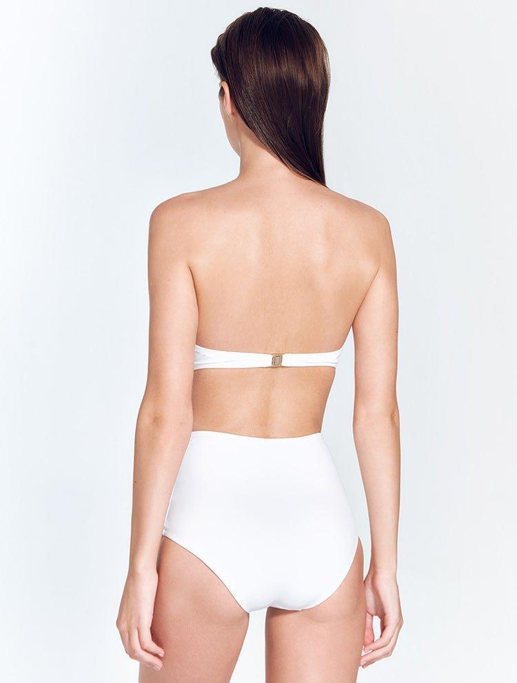 "Model wearing the Livia White Bikini Bottom from the back. The bottom features moderate coverage and a fully lined, high-waisted silhouette for a sleek appearance."