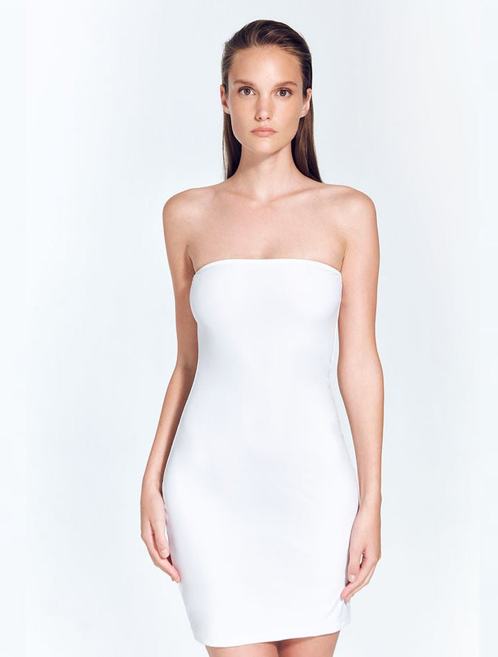 Front View: Model in Logan White Dress - MOEVA Luxury Swimwear, Strapless Neck, Close Fit, Mid-Thigh Length, Fully Lined, MOEVA Luxury Swimwear
