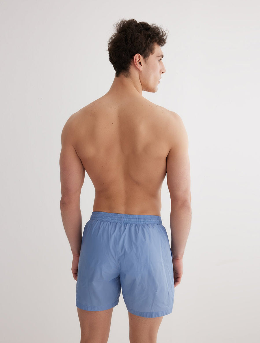 Back View: Model in Louis Blue Shorts - MOEVA Luxury Swimwear, Men Swim Shorts, Nikel, Mid Length Swim Shorts, Fully Lined, Slim Fit, Quick Dry, MOEVA Luxury Swimwear