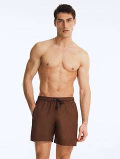 Front View of Model Wearing Louis Brown Shorts - Close Fitting, Lightweight Fabric with Quick Drying, Pockets at the Front, MOEVA Luxury Swimwear 