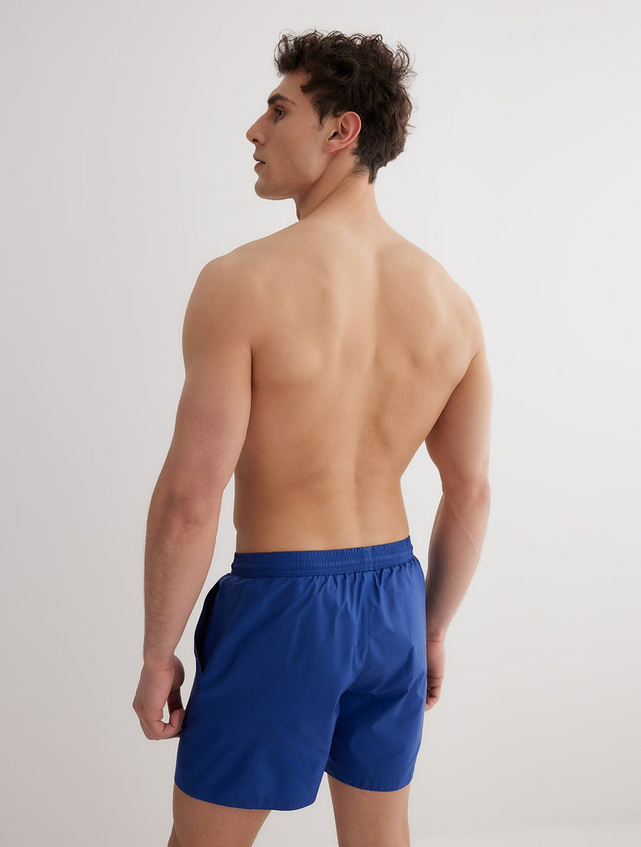Back View: Model in Louis Dark Blue Shorts - MOEVA Luxury Swimwear, Men Swim Shorts, Nikel, Mid Length Swim Shorts, Fully Lined, Slim Fit, Quick Dry, MOEVA Luxury Swimwear