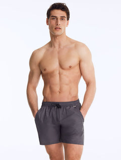 Front View of Model Wearing Louis Dark Grey Shorts - Close Fitting, Lightweight Fabric with Quick Drying, Pockets at the Front, MOEVA Luxury Swimwear 