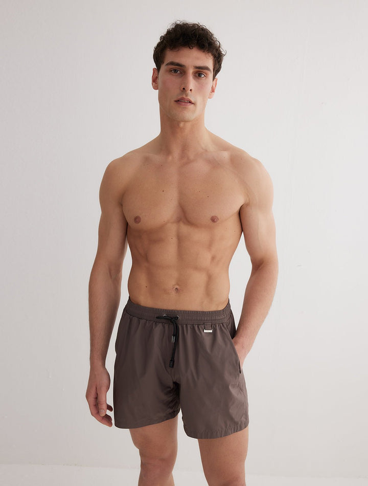 Front View: Model in Louis Grey Swim Shorts - MOEVA Luxury Swimwear, Close Fitting, Lightweight Fabric with Quick Drying, Pockets at the Front, Drawstring Waist, Quick Dry,  MOEVA Luxury Swimwear