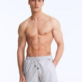 Front View of Model Wearing Louis Light Grey Shorts - MOEVA Luxury Swimwear, Close Fitting, Lightweight Fabric with Quick Drying, Pockets at the Front, MOEVA Luxury Swimwear