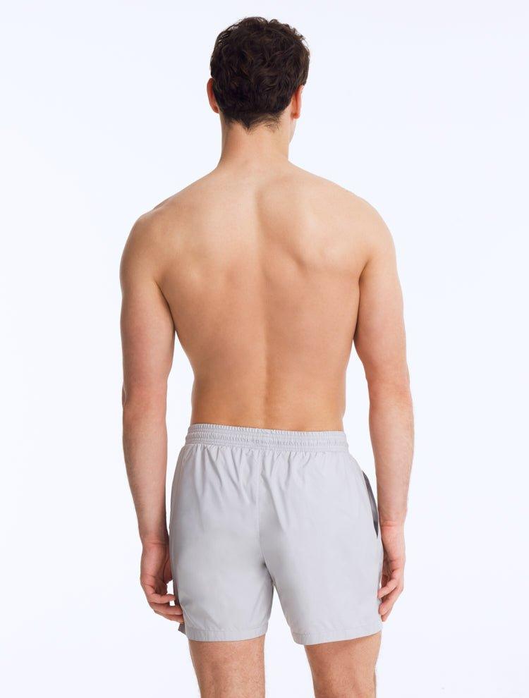 Back View: Louis Light Grey Shorts on Model - MOEVA Luxury Swimwear, Drawstring Waist, Mid Length, Quick Dry, MOEVA Luxury Swimwear   