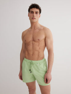 Front View: Model in Louis Mint Green  Shorts - MOEVA Luxury Swimwear, Close Fitting, Lightweight Fabric with Quick Drying, Pockets at the Front, Drawstring Waist, Quick Dry,  MOEVA Luxury Swimwear