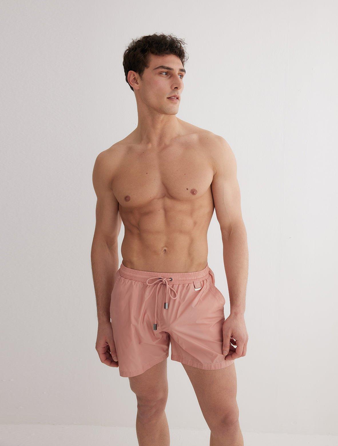 Front View: Model in Louis Old Rose Shorts - MOEVA Luxury Swimwear, Close Fitting, Lightweight Fabric with Quick Drying, Pockets at the Front, Drawstring Waist, Quick Dry,  MOEVA Luxury Swimwear