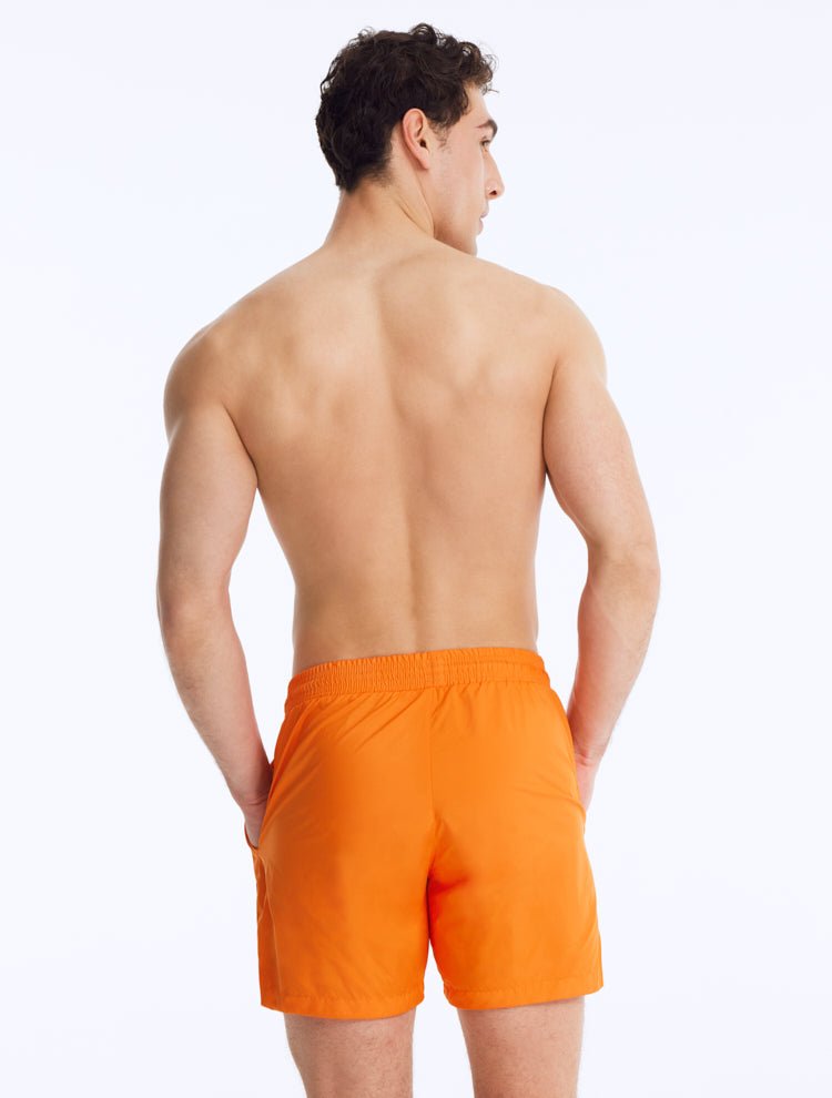 Back View: Louis Orange Shorts on Model - Drawstring Waist, Mid Length, Quick Dry, MOEVA Luxury Swimwear   