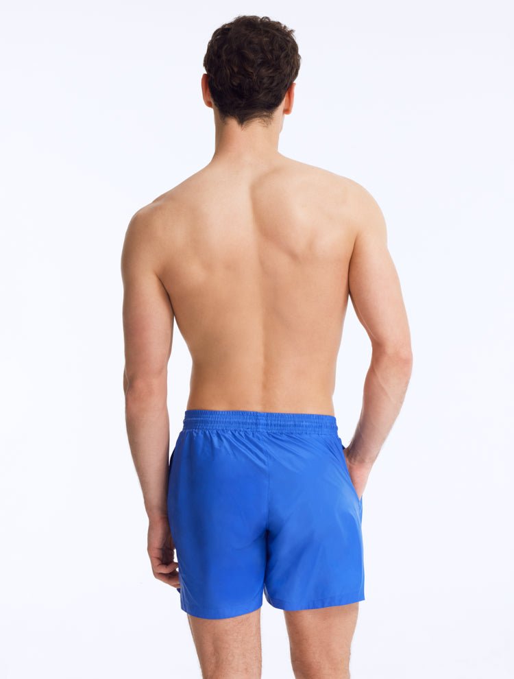 Back View: Louis Sax Blue Shorts on Model - Drawstring Waist, Mid Length, Quick Dry, MOEVA Luxury Swimwear   