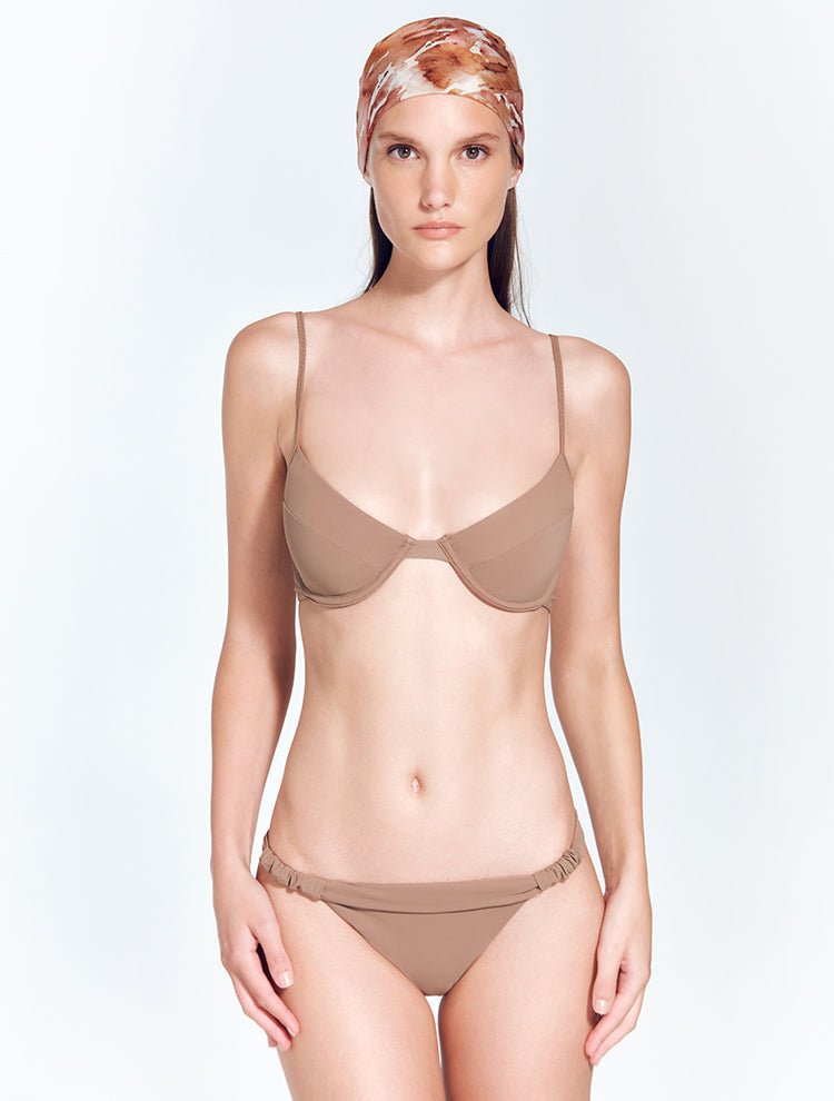 Front View: Model in Lucille Nude Bikini Bottom - MOEVA Luxury Swimwear, Ruched Details, Brazilian Bottom, Butt Lifting Effect, Low Rise, MOEVA Luxury Swimwear